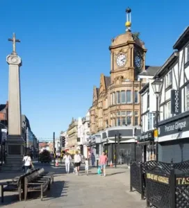 Image of Bolton, Greater Manchester, UK: Urban landscape with buildings, streets, and people in a bustling city setting.