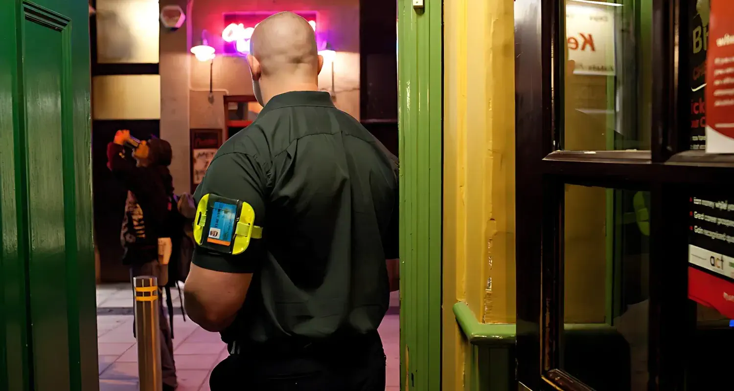 Sia licenced door supervisor of guard mark monitoring the entrance to ensure the bar's security.