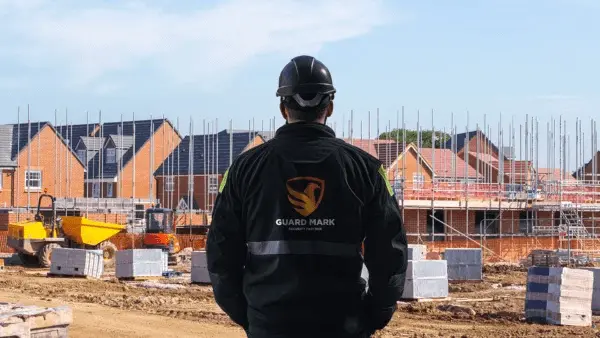 Construction site security guard performs duties at the construction site, ensuring safety and security effectively.